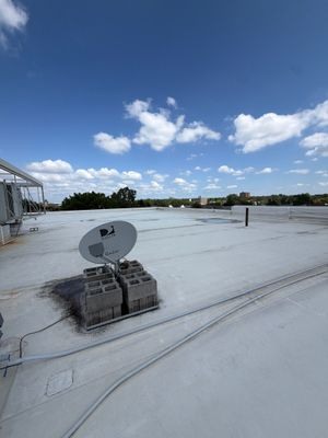 Open TPO roof areas, perimeter flashing and rooftop penetrations at the Columbus healthcare building.